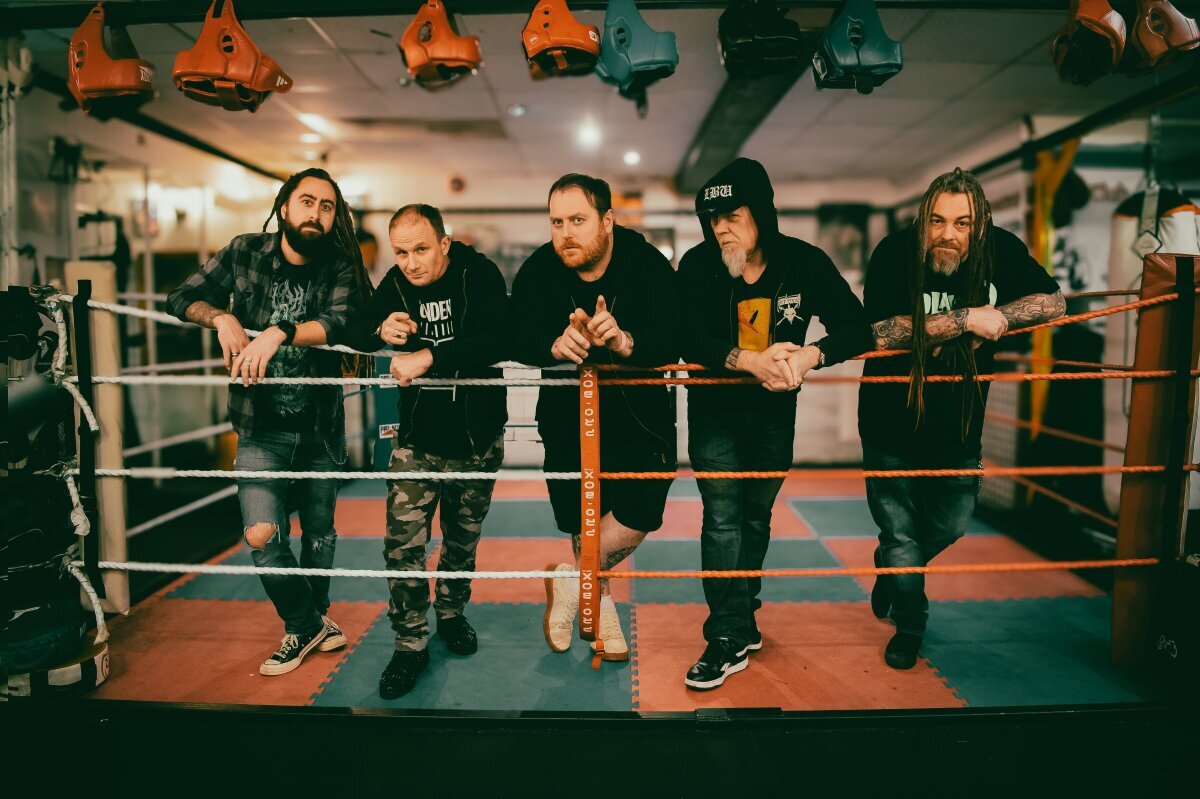 Acid Reign band members smiling for a photo